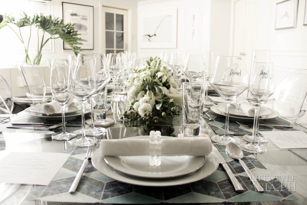 Place mats designed by Ria Francisco Preito add color to Maureen's all white and glass set-up