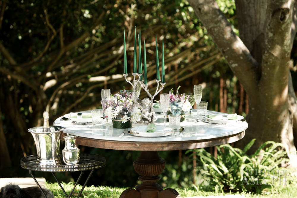 An antique marble table top with set-up under the shade of the lush trees