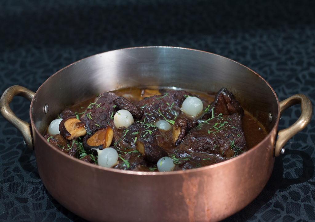 Beef bourguignon - stew prepared with beef braised in red wine, traditionally red Burgundy, and beef broth, generally flavored with garlic, onions and a bouquet garni, with pearl onions and mushrooms added towards the end of cooking.