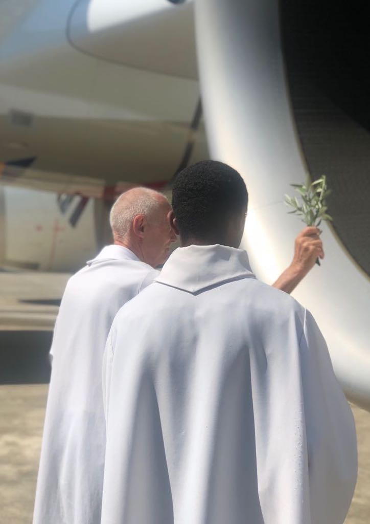 Priests bless the new aircraft before its flight to Manila