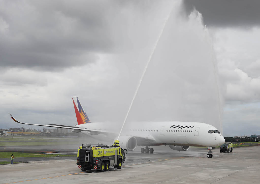 Trucks with water canons waited on the runway, waiting to welcome the A350-900 with a dousing.