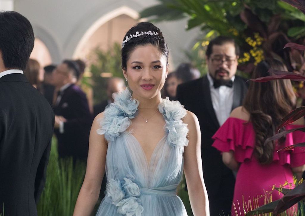 Constance Wu as Rachel Chu wearing a Marchesa dress and a handcrafted Jennifer Bahr head piece
