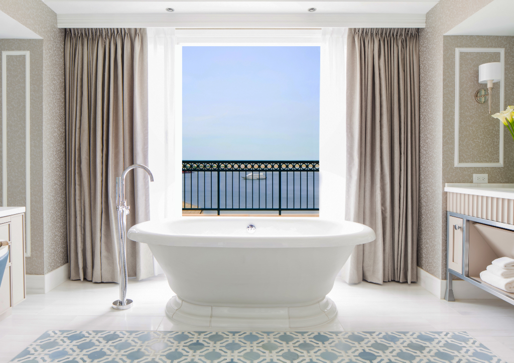 The master bath is equipped with Carrara marbled bath, a double-vanity free-standing soaking tub overlooking the harbor, a Toto toilet, separate rain shower and a personal dressing room. Amenities are by Bulgari. (Photo courtesy of Boston Harbor Hotel)