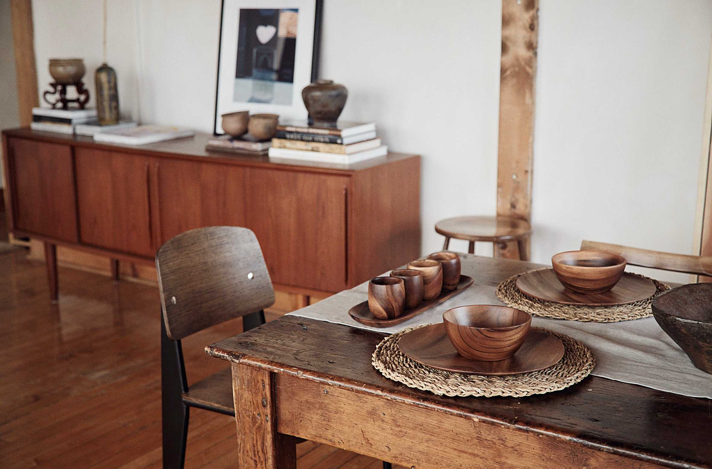 The dining table (with wooden bowls and trays from Baguio) was originally a harvest table used by the Mennonites in the 1800s; the side cabinet was purchased online.