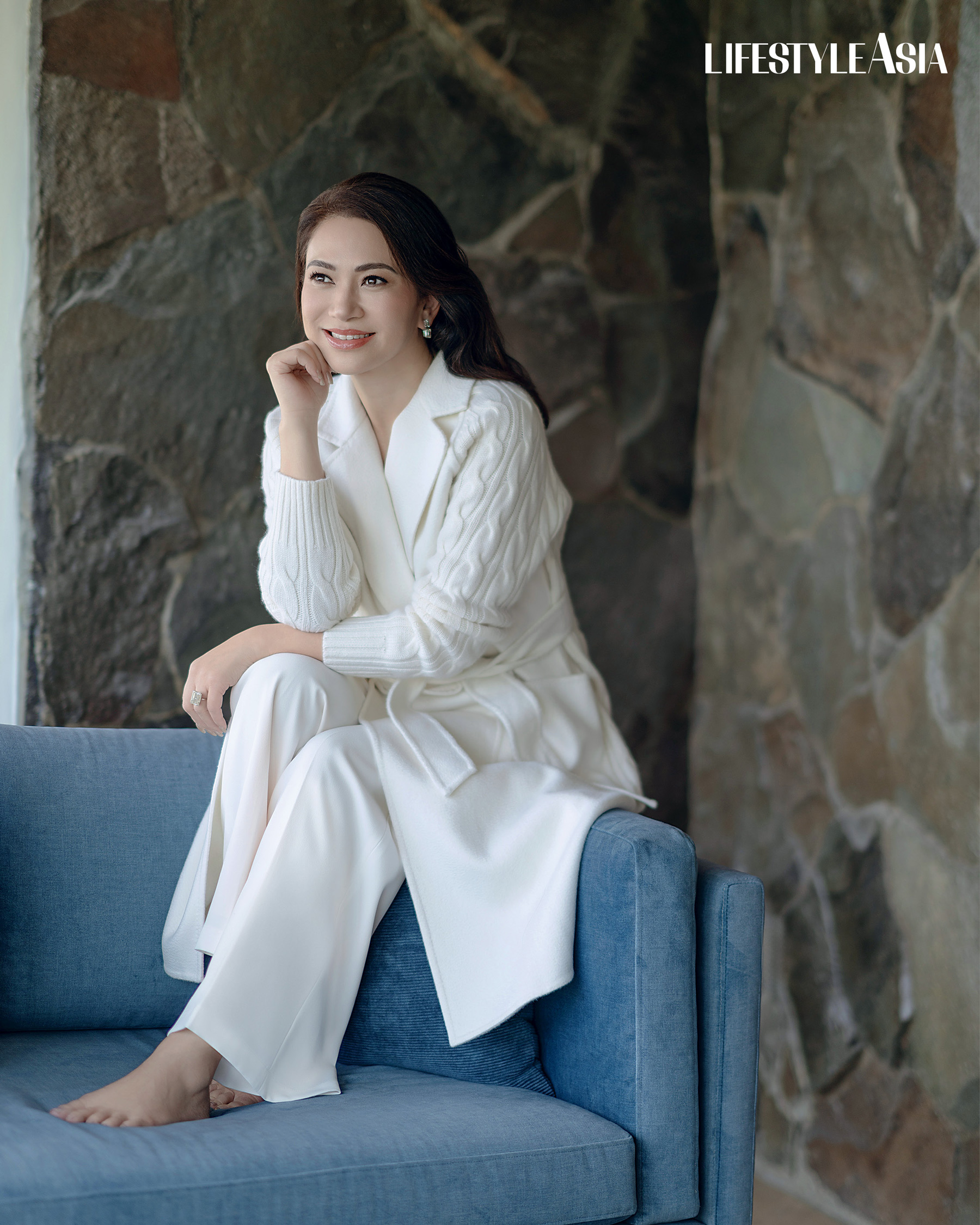 Ivory cashmere cable knit trench coat and trousers, MAX MARA; Asymmetric diamond dangling earrings and ring, JMA JEWELRY.