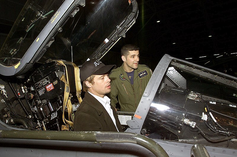 Actor Brad Pitt site in the cockpit of a Royal Air Force (RAF) GR3A Jaguar aircraft as RAF Flight Lieutenant, Rich Wells looks on, at Incirlik AB, Turkey. Brad Pitt and member of the Warner Brother's movie "Ocean's 11" crew visited with deployed military personnel during Operation Nothern Watch.