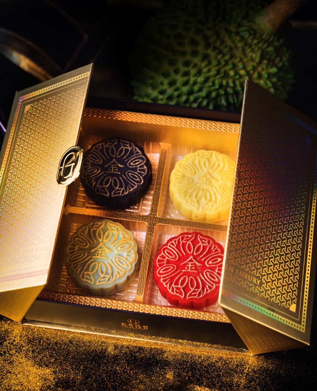 Mooncakes are packed into a glistening gold box