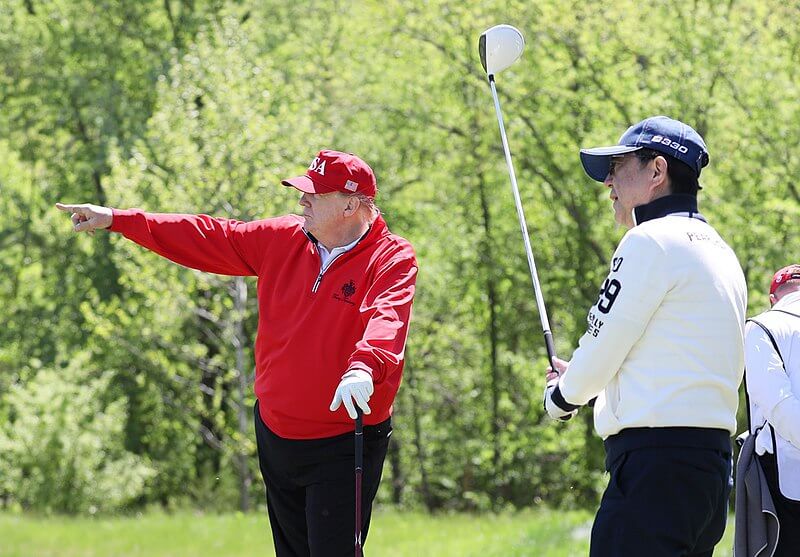 Shinzo Abe and Donald Trump playing golf in 2019.