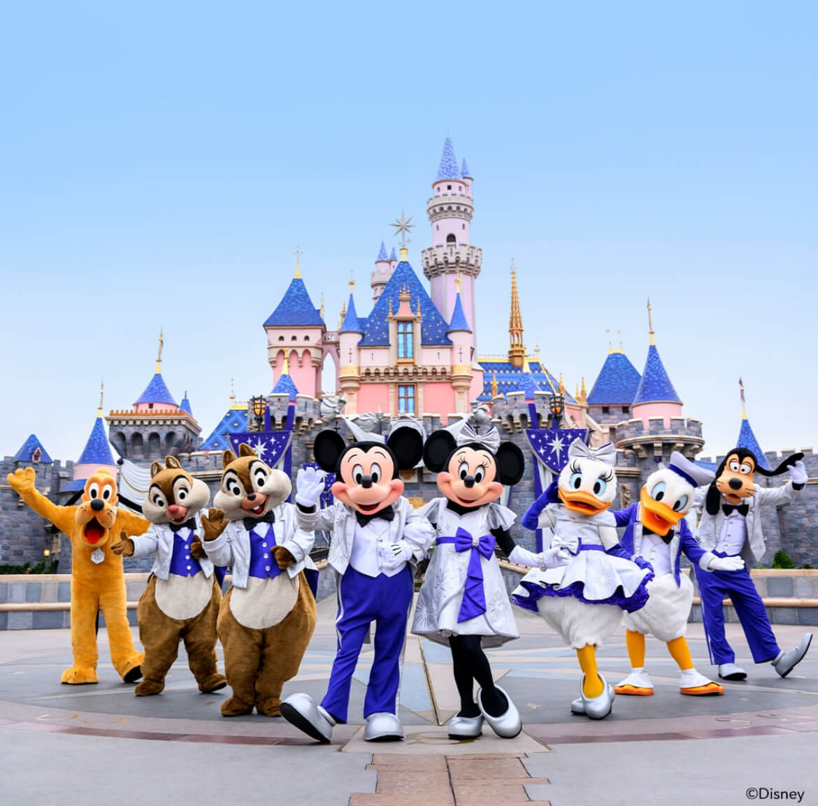 Mickey Mouse and friends in front of the iconic Walt Disney castle.