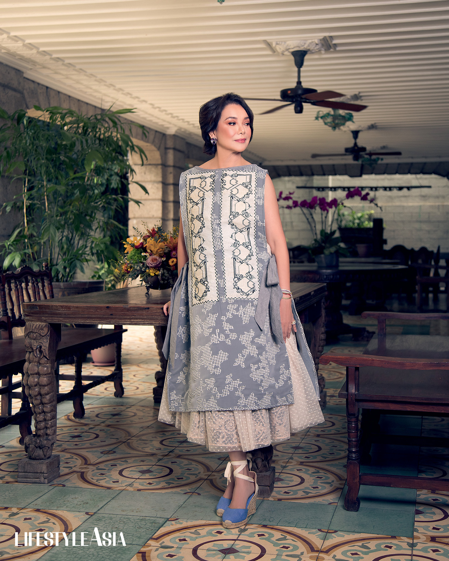 Gray embroidered apron dress and lace and tulle skirt, JOR-EL ESPINA; Multicolored gemstone earrings, JMA JEWELRY.