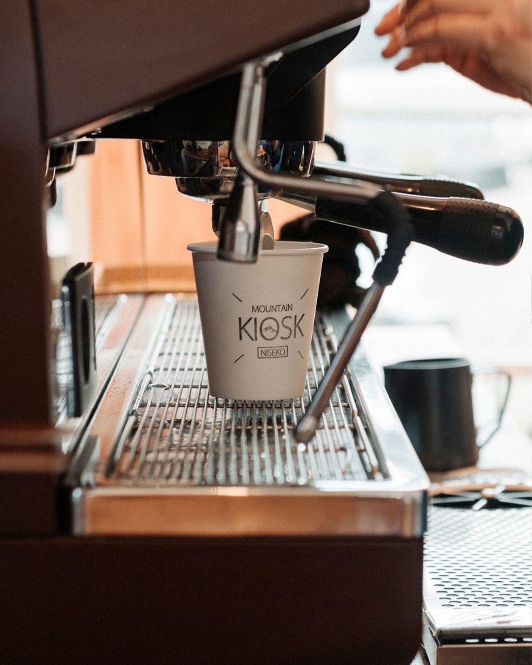 Grab a coffee to go at Mountain Kiosk Coffee by the base of Hirafu Ski Slopes