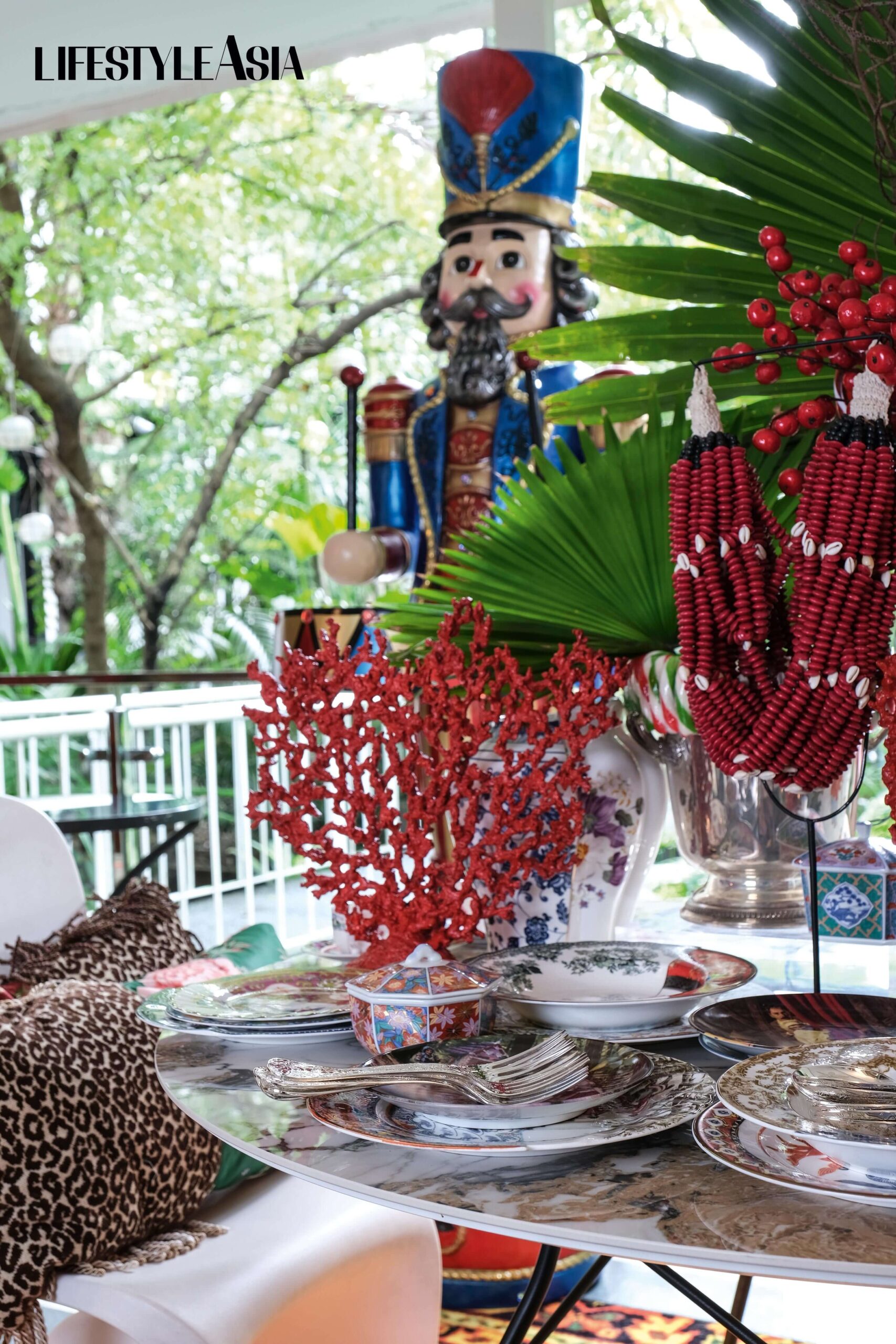 A life-size toy soldier watches over the table, set with different plates and other accessories and decor expertly layered by Chat.