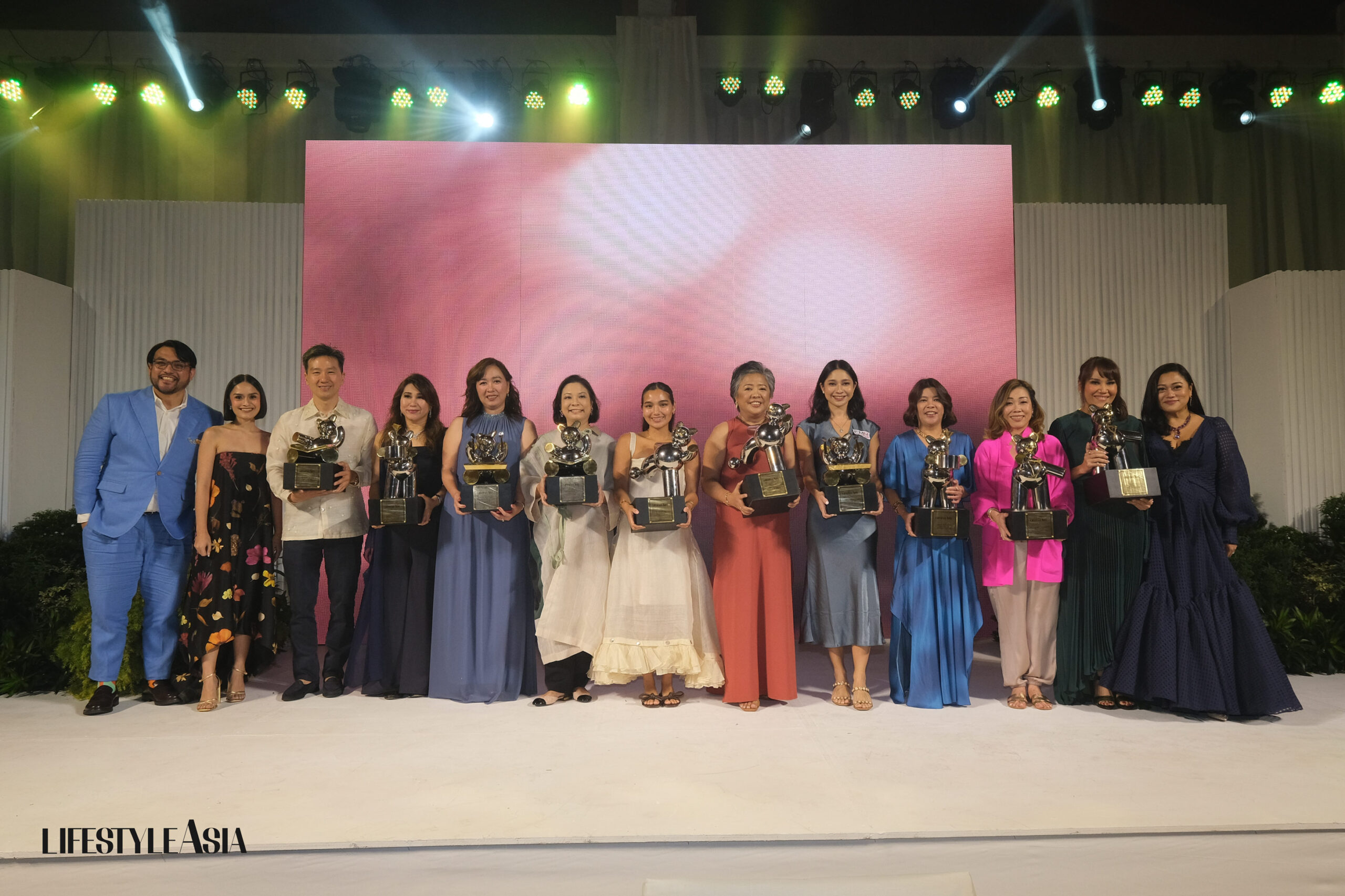 All awardees on stage holding a one-of-a-kind bear trophies Nixxio Castrillo designed