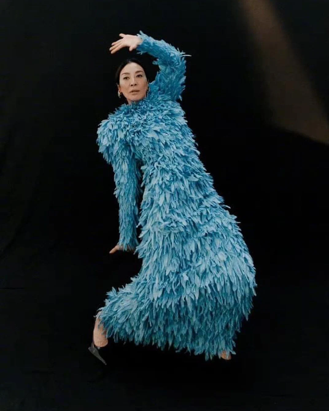 October 2022 saw her adorned in a long-sleeved blue feathered gown for Vogue China.
