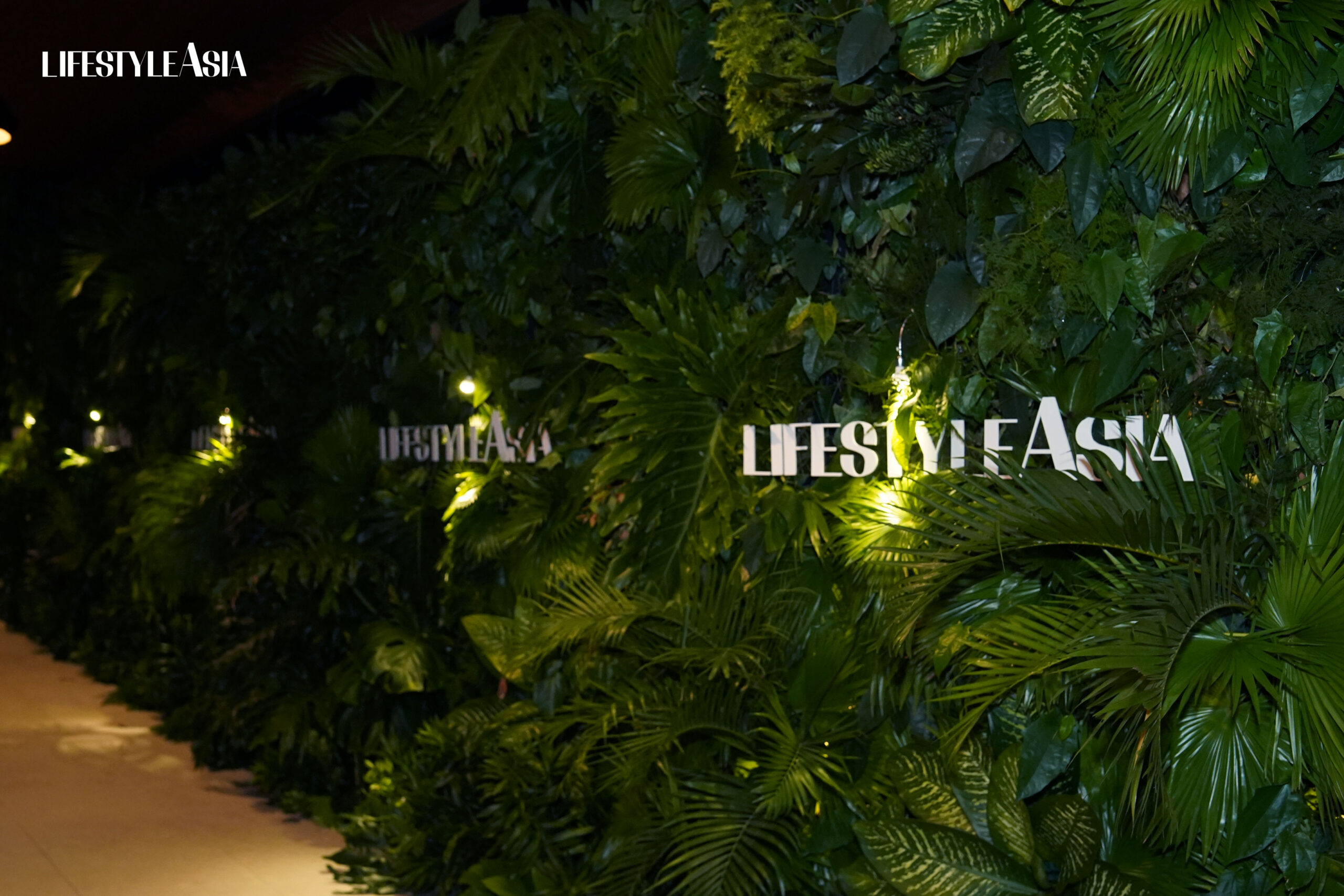 The lush, foliage photo wall where guests had their pictures taken