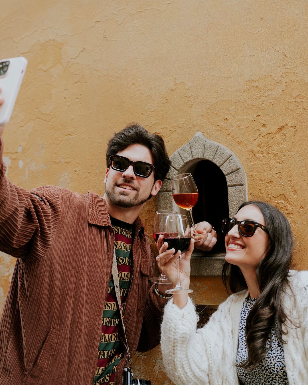 Guests enjoying wine by Babae bistro's wine window in Florence