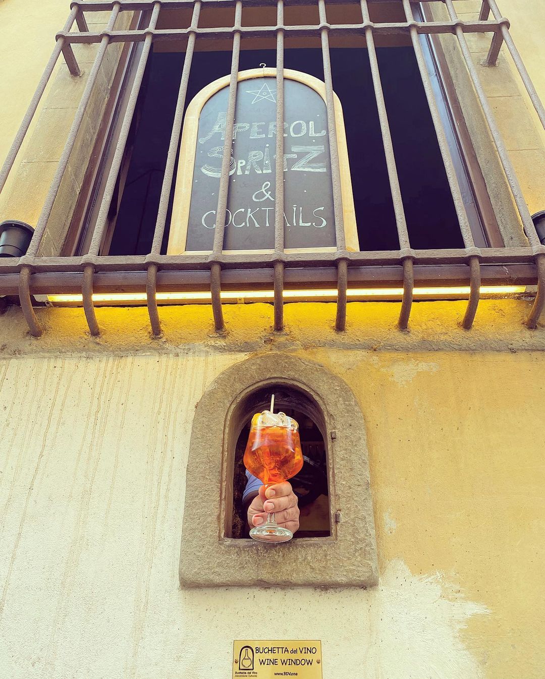 The wine window of Osteria delle Brache, where guests can get a serving of cocktails or Aperol spritz