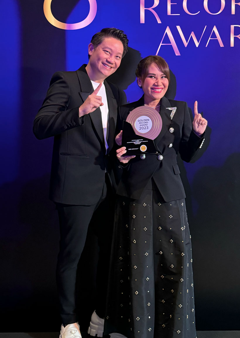 Dr. Z Teo and Dr. Aivee Teo holding their Golden Record Award 2023.