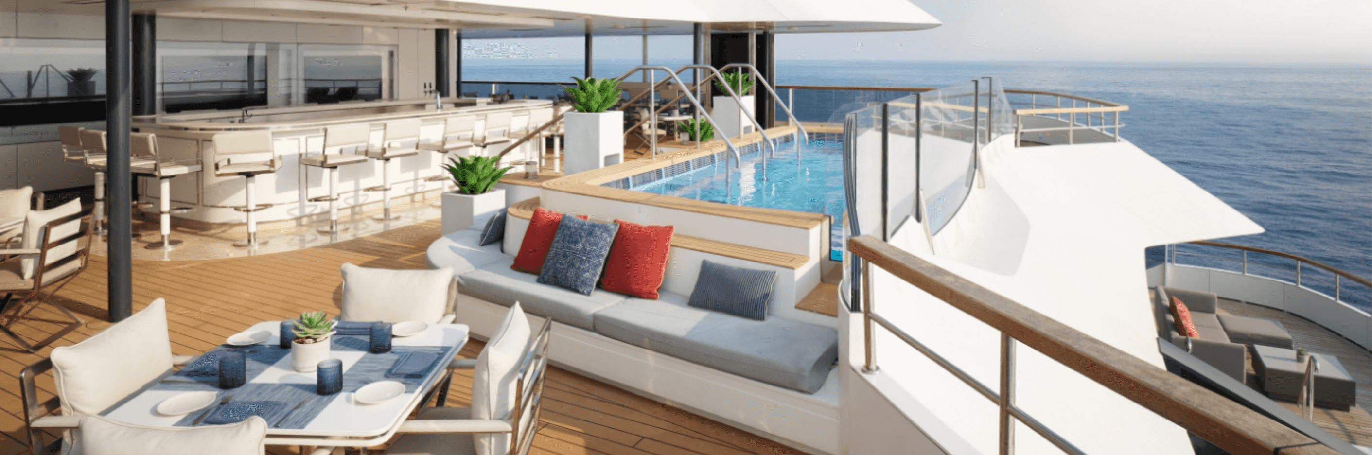 A panorama of a relaxing outdoor deck aboard the Ritz Carlton Evrima