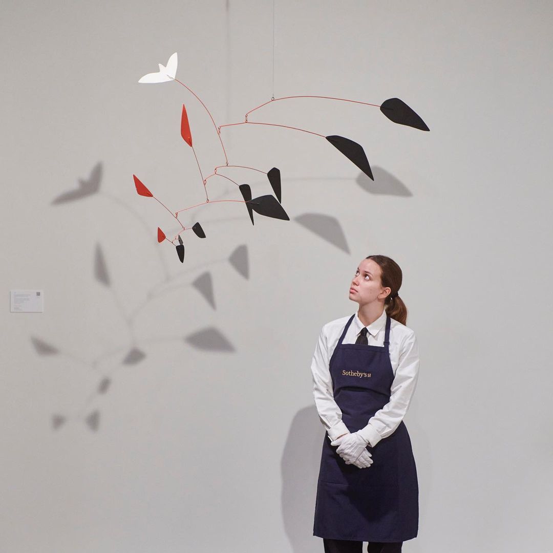 A Sotheby’s staff member next to Alexander Calder’s “Le Lys” hanging mobile (1964)