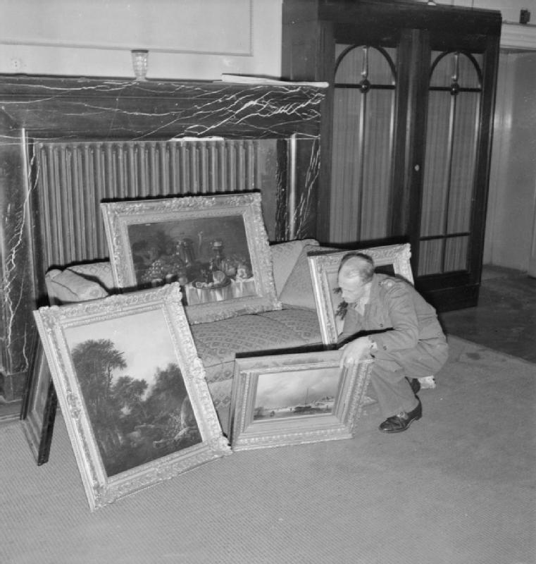 Captain H H Davies of Birkenhead checking a collection of art that Nazis looted from Holland, a common reason why many works of art have gone missing over the past few decades