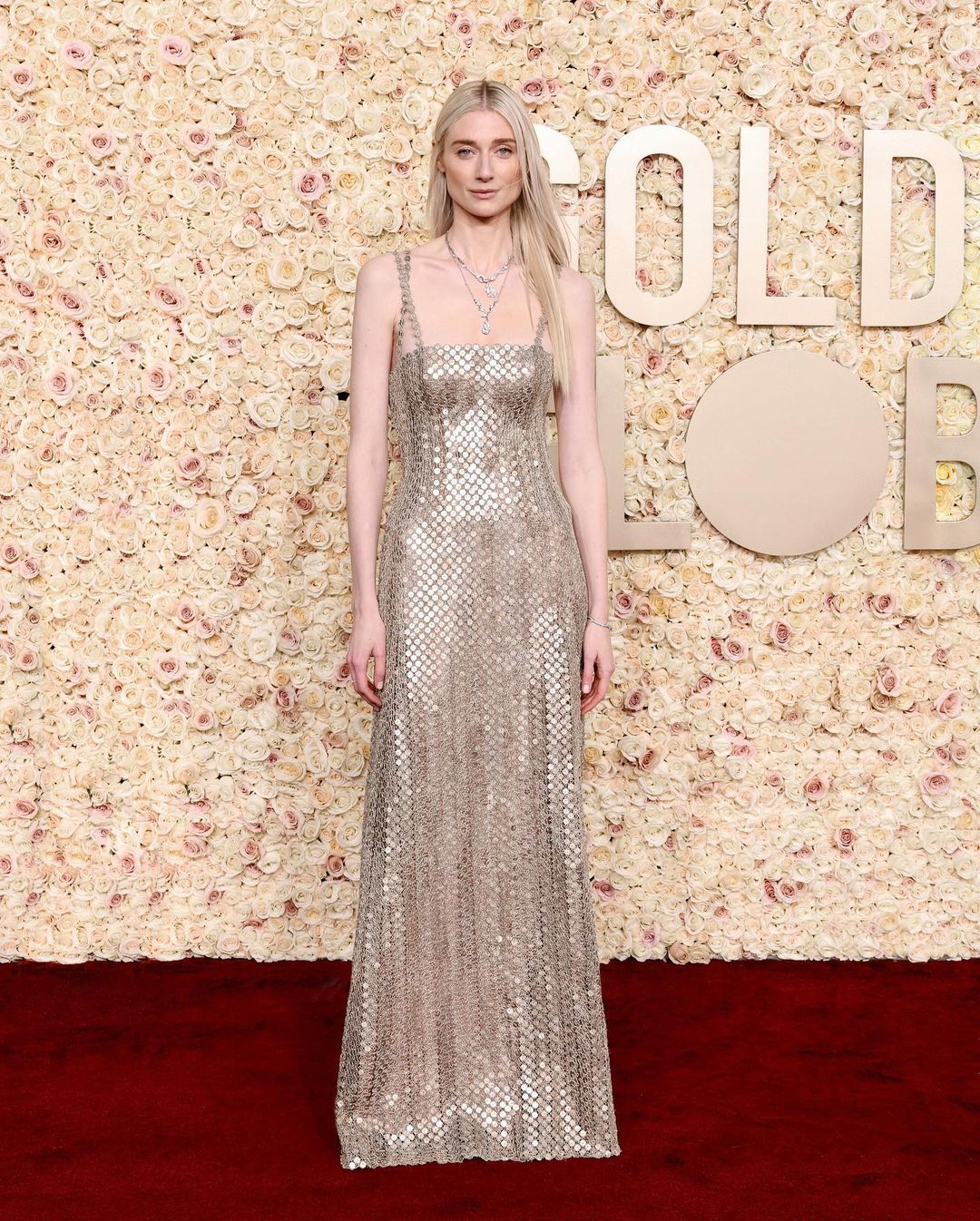 Elizabeth Debicki wearing a couture gown with silver disks and jewelry from Dior