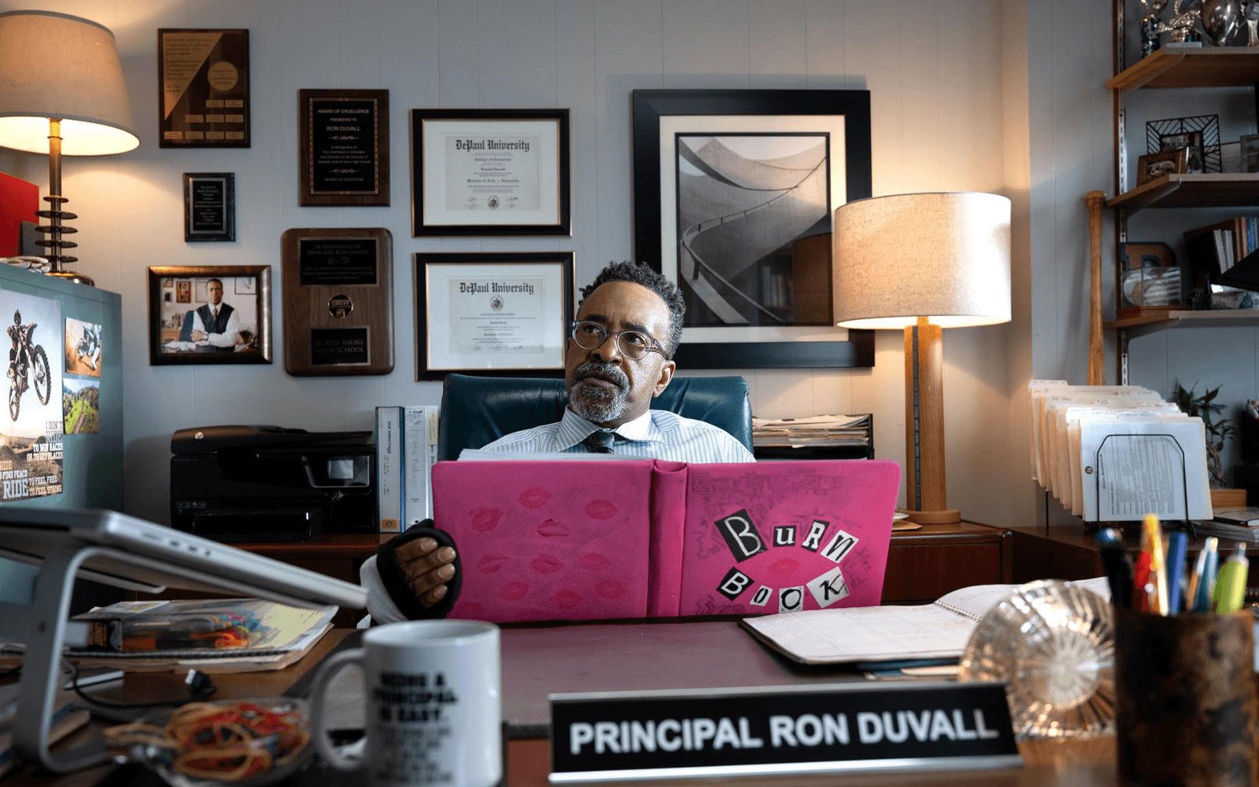 Tim Meadows return to "Mean Girls Musical" film as Principal Duvall, who is holding the iconic pink burn book