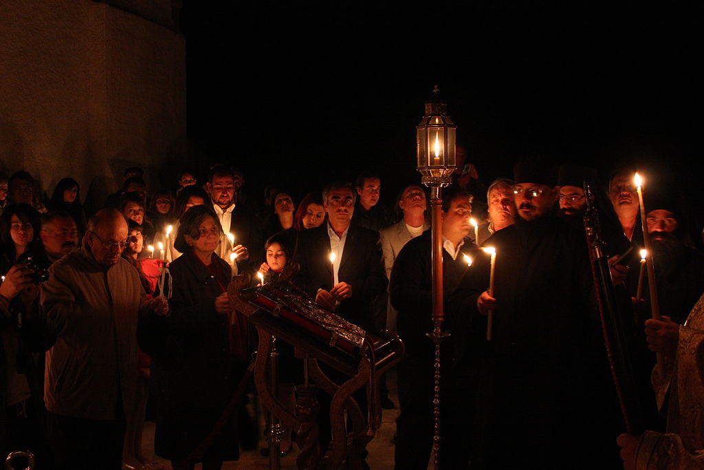 People with lighted candles symbolizing Jesus rising from the dead