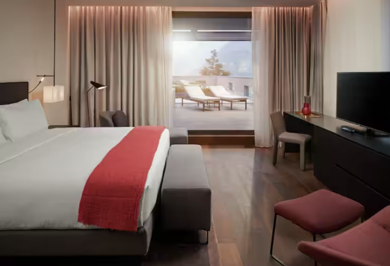 Hilton Lake Como's Presidential Suite bed faces an outdoor lounge area
