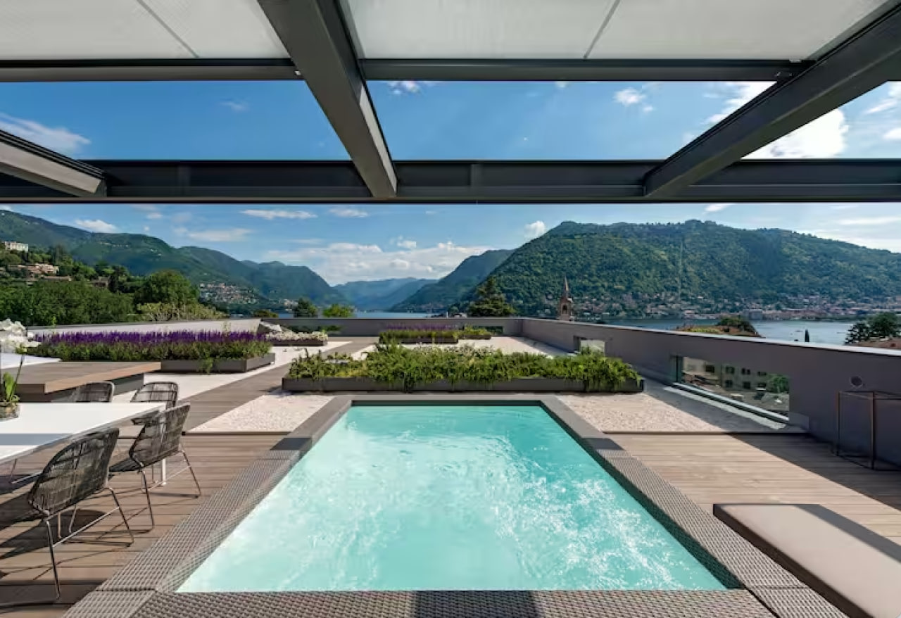 The outdoor pool in the rooftop terrace overlooking picturesque lake views