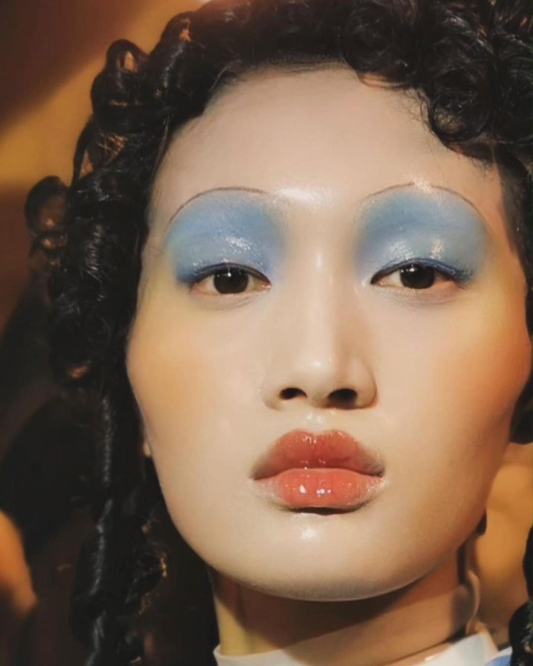 Pat McGrath made use of light smoky eyes and a doll-like blush to complete the glass skin look