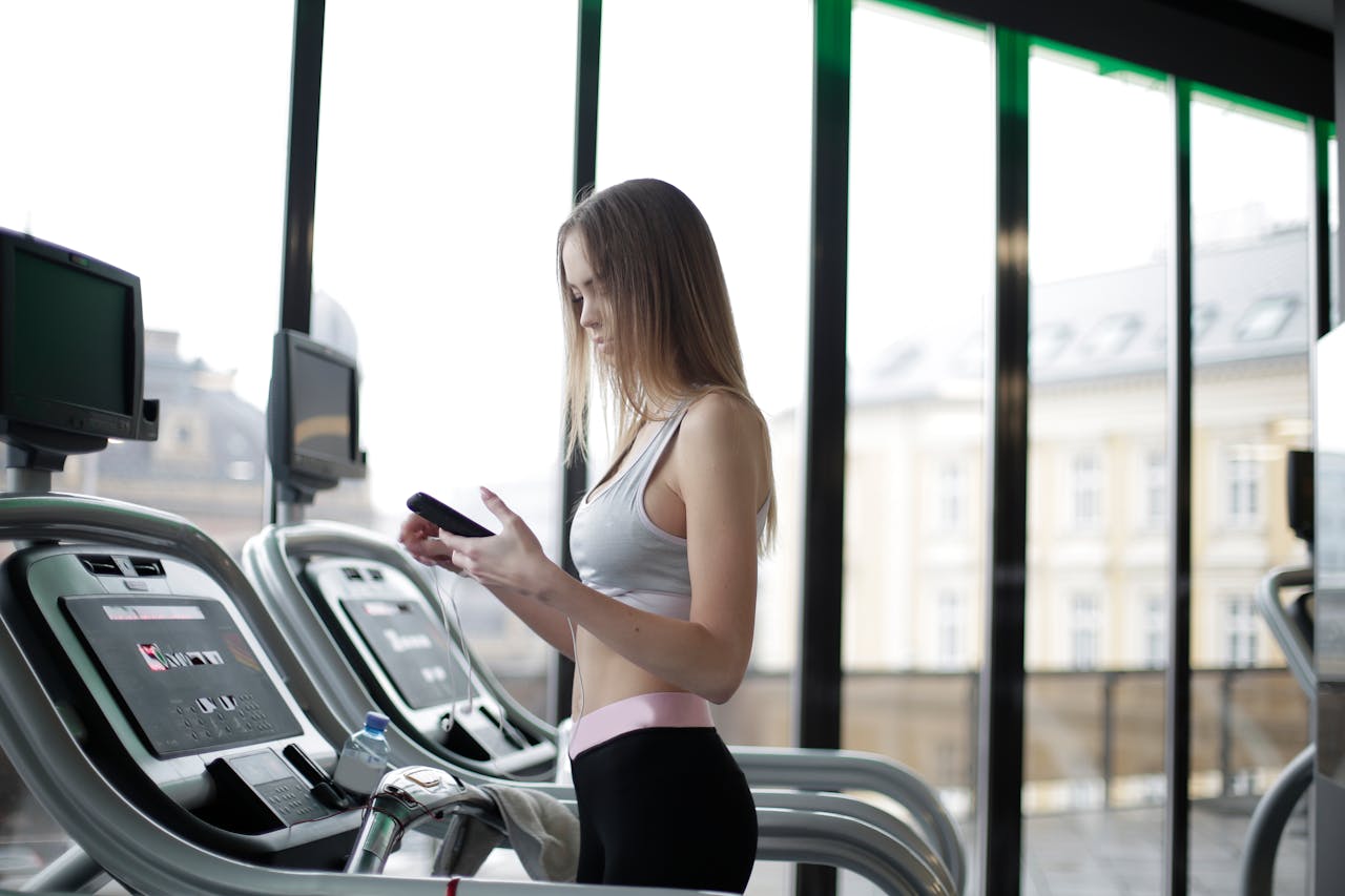 Woman on treadmill on her phone