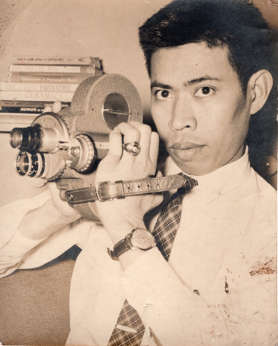 A young Abdulmari Imao holding a camera
