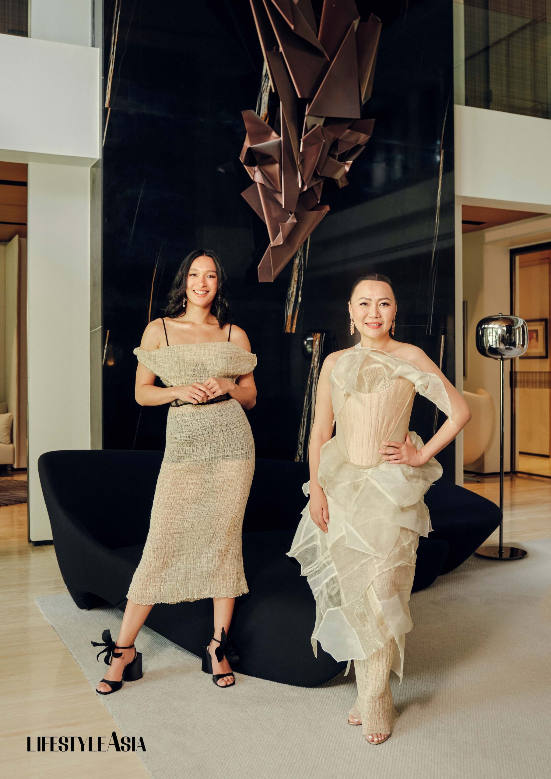 ON BEA: Smocked piña off-shoulder dress with a black corset belt, RAJO LAUREL; Earrings, JUL B DIZON JEWELLERY; Black sandals, NUMERO VENTUNO; ON BENG: Love letter barong tunic and blouse, smocked piña skirt and corset, RAJO LAUREL; Coral earrings, JUL B DIZON JEWELLERY