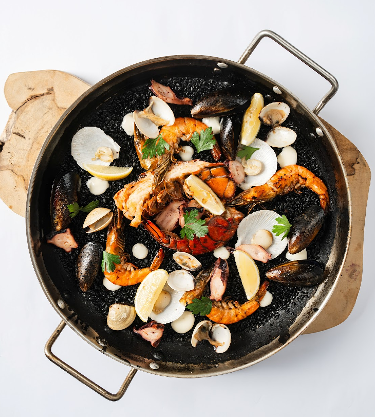 TOP LEFT: Squid Ink Paella with Seafood; TOP RIGHT: Seafood Platter (Maine Lobster, Pulpo, Prawn and Hamachi Collar); BOTTOM LEFT: Iberian Chicken; BOTTOM RIGHT: Duck Confit Adobo a la Orange