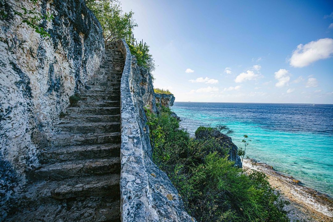 Rock formations and cliffs conveniently face the clear blue sea