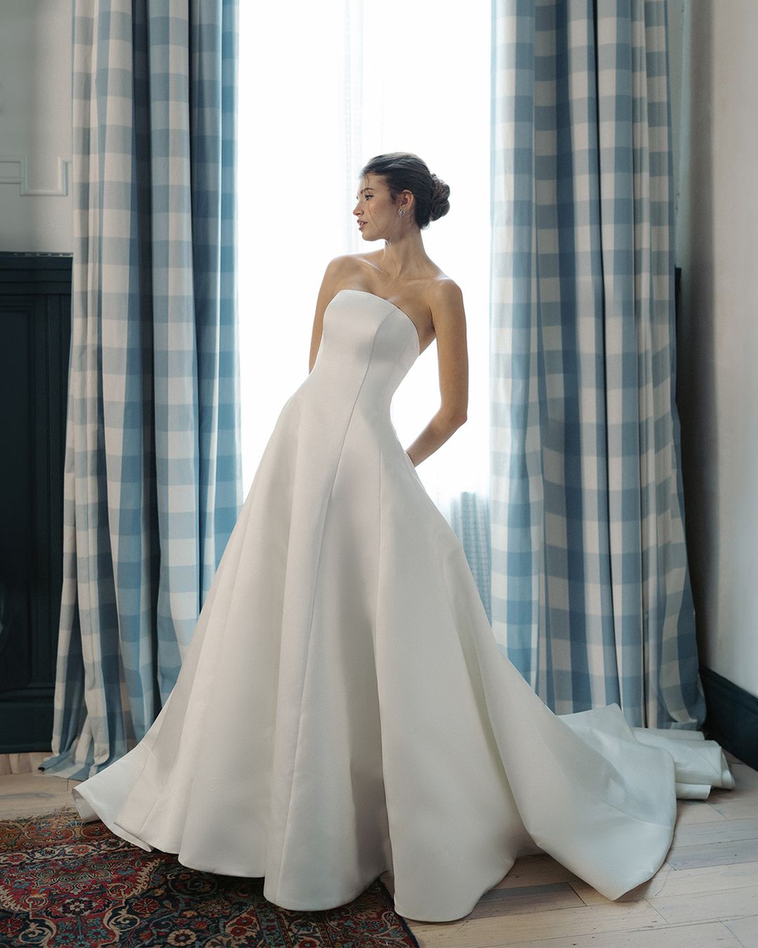 An A-line gown with an arched neckline and train