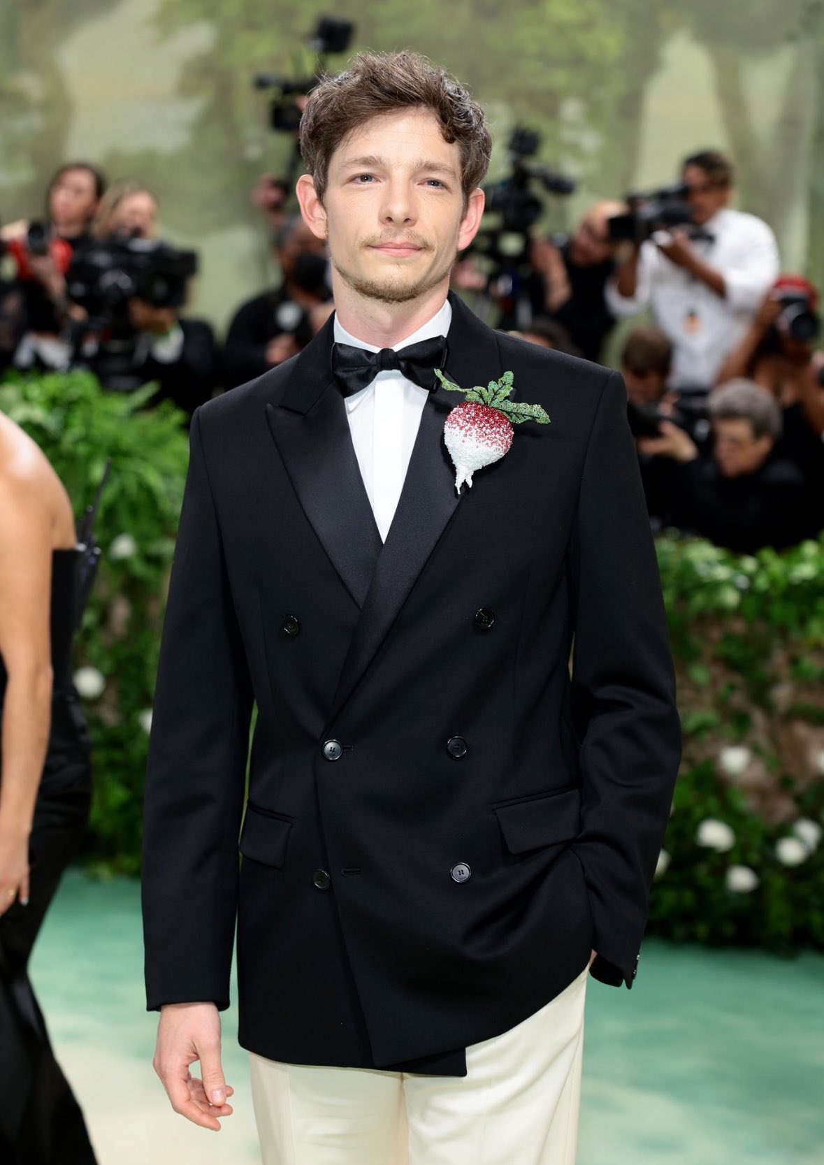 Mike Faist’s Met Gala look features an interesting touch to his attire–an embellished radish brooch