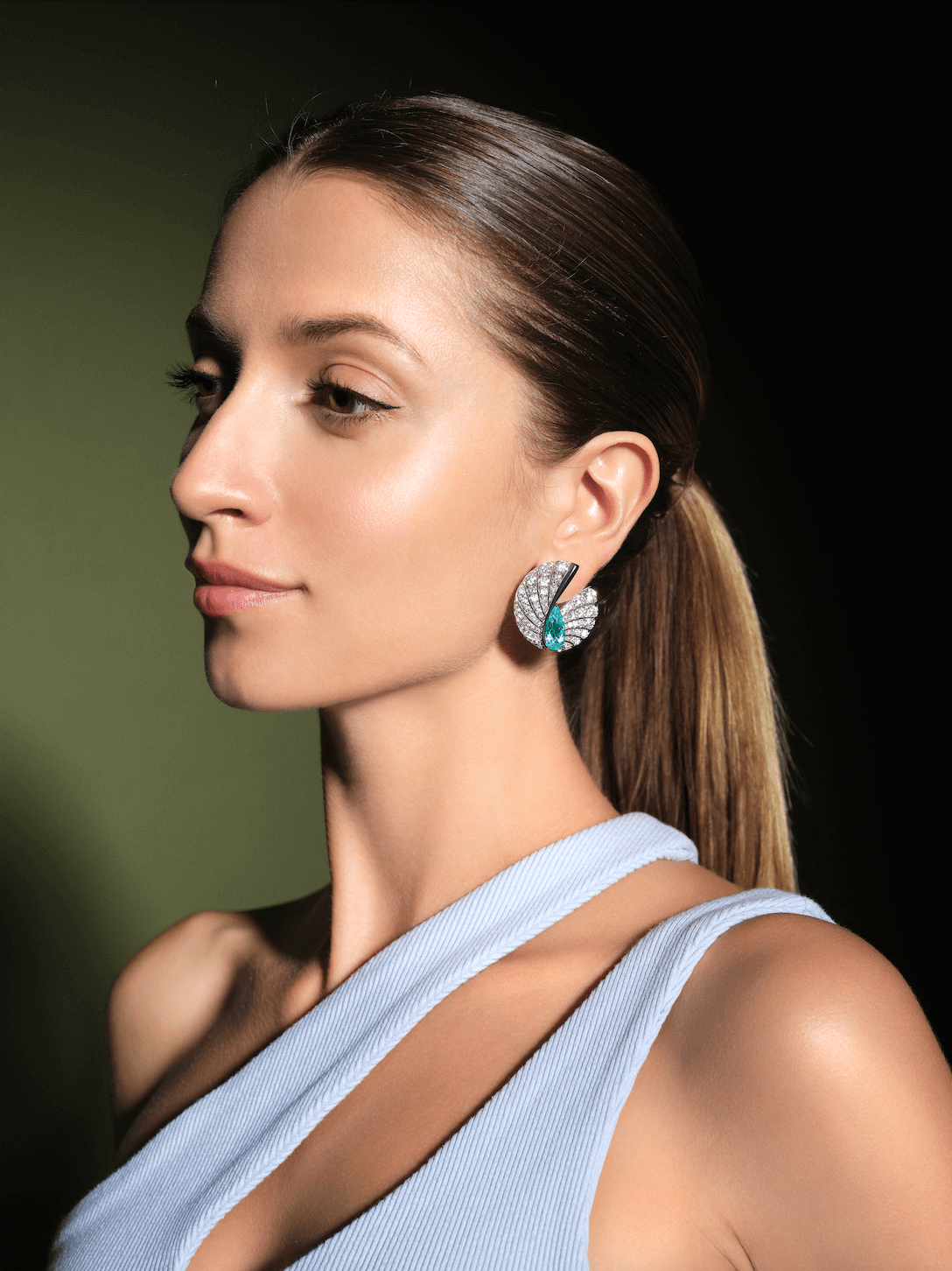 Model wearing Paraiba tourmaline and diamond earrings by Forms Jewellery