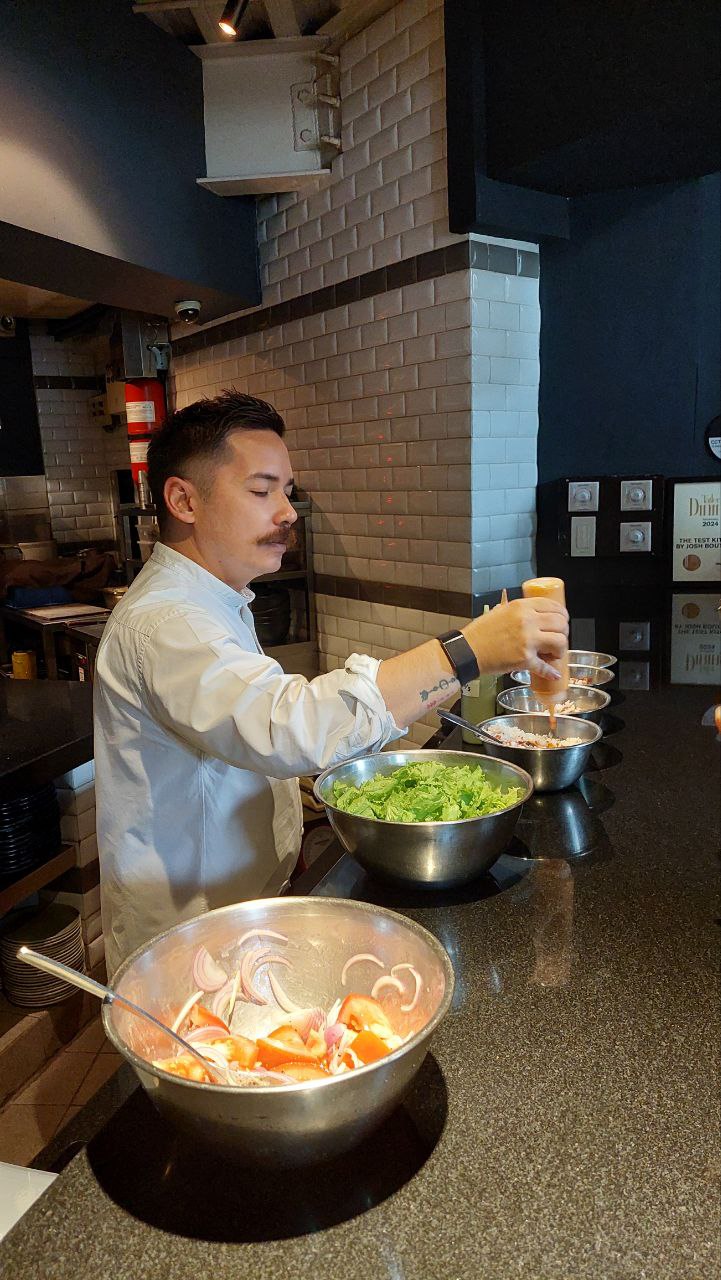 Boutwood mixing gochujang sauce into a grains bowl and making a French vinaigrette healthy meal prep